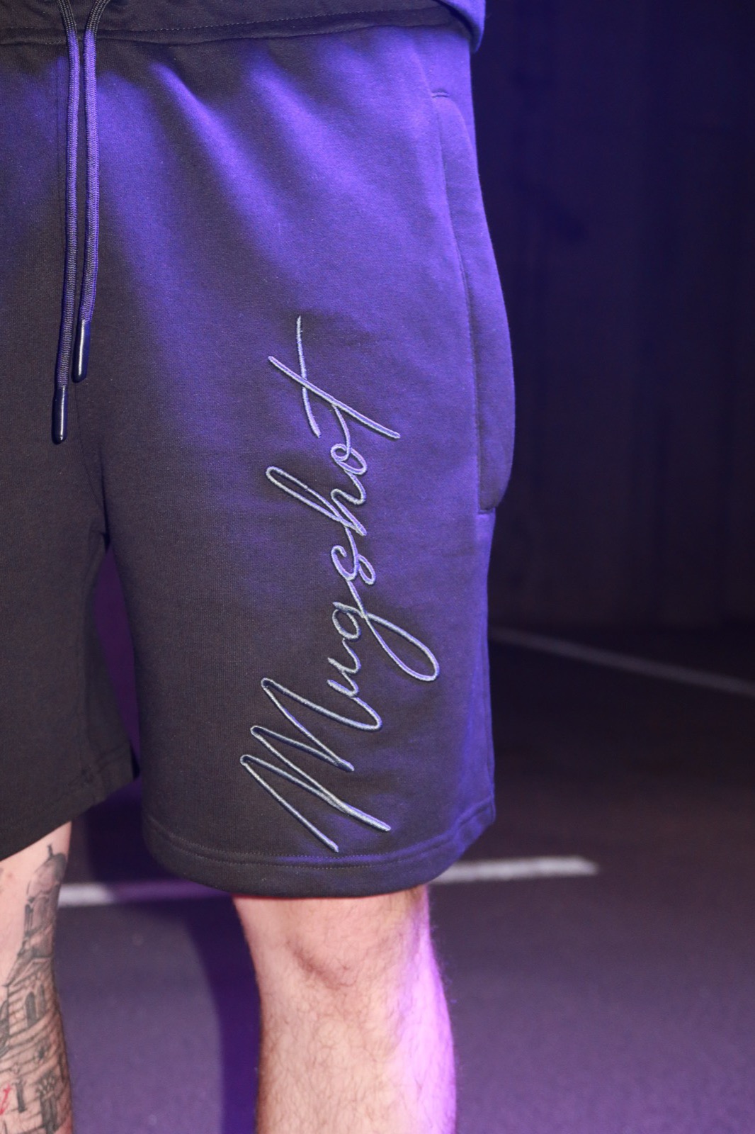 TNG Mugshot capsule — embroidered pocket detail